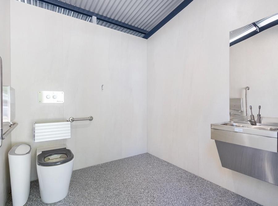 What materials ensure durability in high-traffic public toilets?